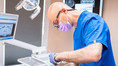 Dentist working on patient in office Photo